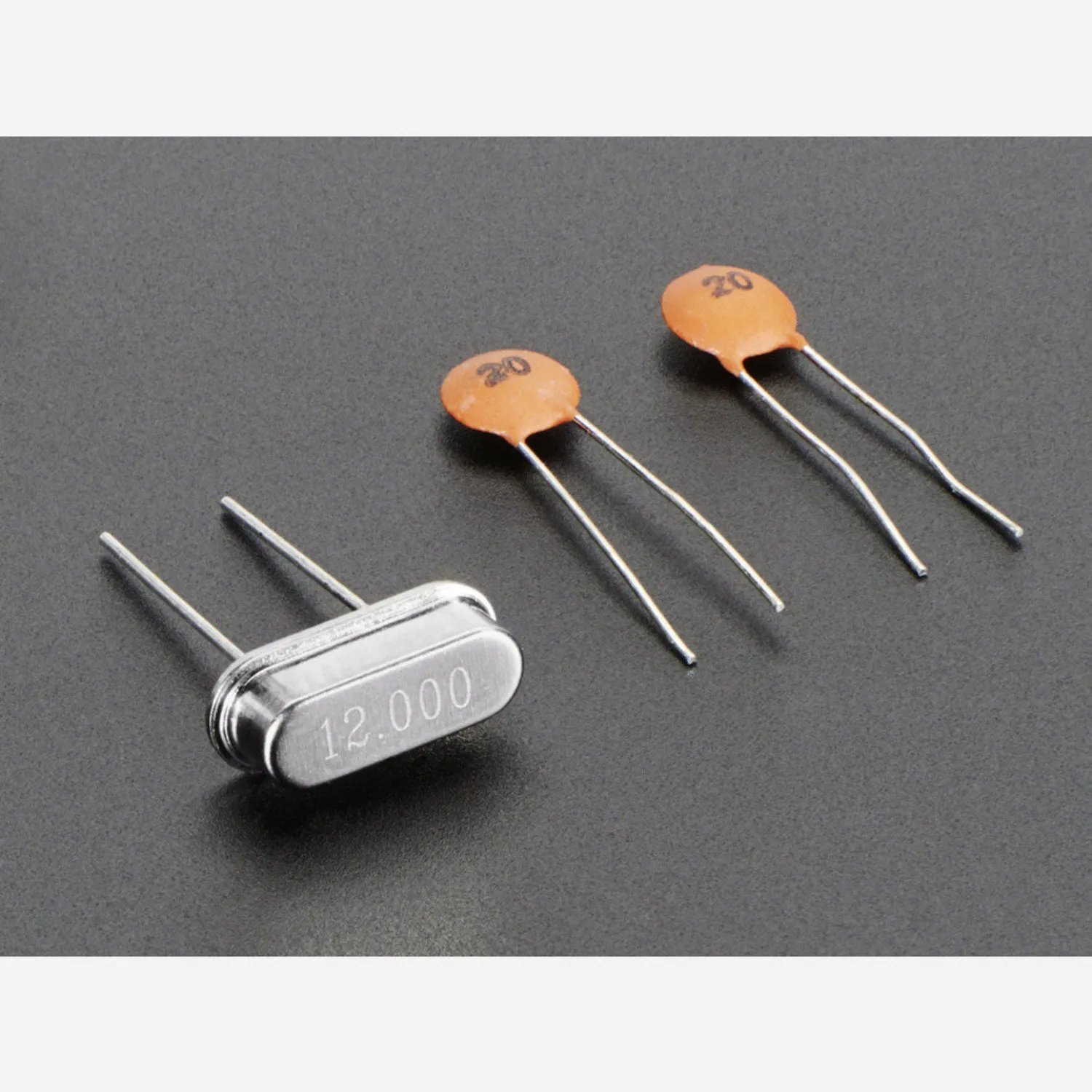 Photo of 12 MHz Crystal + 20pF capacitors
